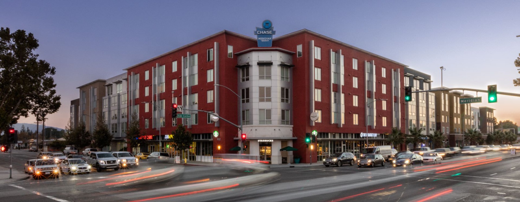 a large building with many cars in front of it