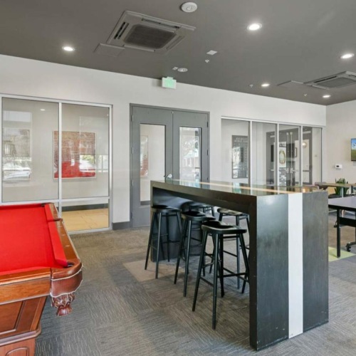 a game room with a pool table and a ping pong table